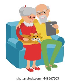 Happy senior man and woman sitting on the sofa read e book and rest. Senior couple read with tablet.