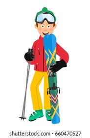 Happy skier wearing red jacket, green hat and goggles holding skis and poles standing over white background
