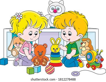 Happy small children playing with their colorful toys in a nursery, vector cartoon illustration on a white background