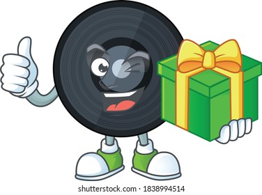 Happy smiley music viynl disc cartoon mascot design with a gift box. Vector illustration