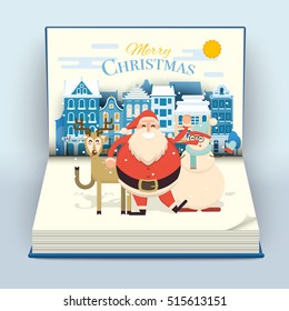 Happy Smiling Cartoon Santa, Deer And Snowman Waving Hands In Cute Town Street Scene On A Blank Open Pop Up Book. Christmas Holiday Decorations. Snowfall On Christmas Eve. Xmas Vector Illustration