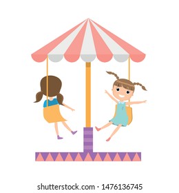 Happy smiling girl in amusement park at carousel