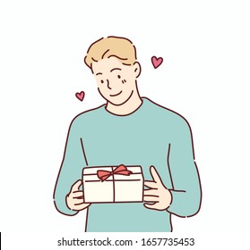 Happy smiling man holding gift box. Hand drawn style vector design illustrations.