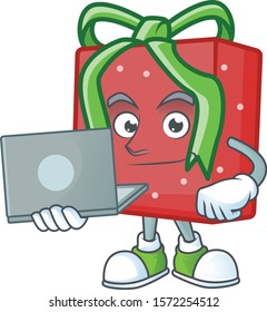 Happy smiling red gift box cartoon character working with laptop
