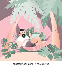 Happy smiling self employed wan with a beard and thumb up lying on a hammock and working remotely on computer in a jungle. A freelancer hipster working on laptop in the summer nature with palm trees.