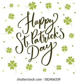 Happy St. Partick's day greeting. Calligraphy design for cards. Typography on white background with green four-leaf shamrocks.