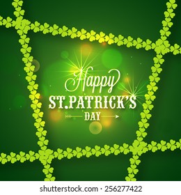 Happy St. Patrick's Day celebration greeting or invitation card decorated by glossy green shamrock leaves.