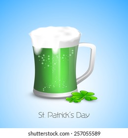 Happy St. Patrick's Day celebration with green beer in a mug and clover leaves on blue background.
