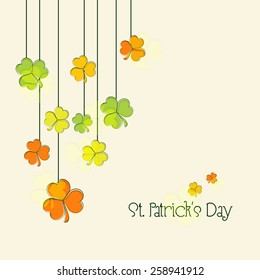 Happy St. Patrick's Day celebration greeting card design decorated with colorful hanging shamrock leaves.