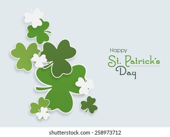 Happy St. Patrick's Day celebration with Irish lucky shamrock leaves on blue background.