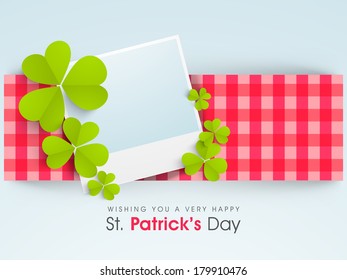 Happy St. Patrick's Day celebrations stylish background with blank note for your message decorated by green shamrock leaves on pink and blue background.