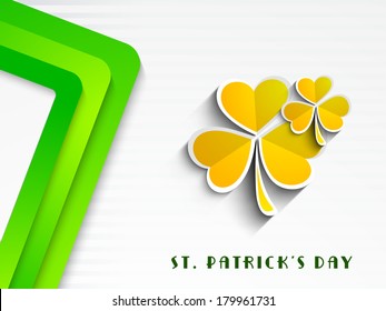 Happy St. Patrick's Day celebrations concept with beautiful golden Irish lucky shamrock leaves on creative green and grey background. 