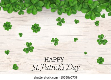 Happy St. Patrick's day. st patricks day design with falling shamrock, four leaved clover on wooden background. Ireland symbol pattern. Design for banner, card, invitation, postcard.