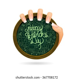 Happy St. Patricks day hand written greetings on chalkboard woman's hand