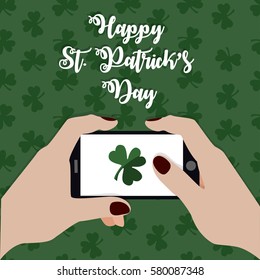 Happy St. Patrick's Day. Hands holding mobile phone and sending shamrock leaf. Instagram blogger. Hand drawn vector flat illustration, 