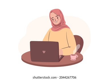 Happy student in hijab. Empowered business woman or freelancer working on laptop. Muslim woman with laptop in cafe or home.