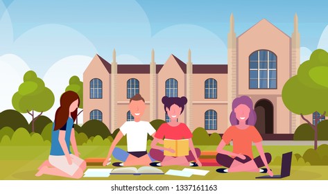 happy students group sitting on grass at campus yard in front of modern national university building exterior people preparing exam graduation education concept flat horizontal