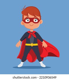 
Happy Super Little Boy Wearing a Red Cloak and Hero Costume. Cool independent child having super powers feeling strong
