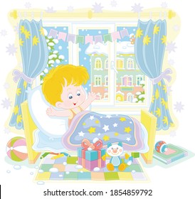 Happy and surprised little boy, waking up in his small bed, with colorful holiday gifts and toys in a nursery room in a snowy winter morning, vector cartoon illustration isolated on a white background
