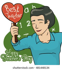 Happy teacher celebrating Teacher's Day with a cute handmade gift in shape heart from his students in the classroom.