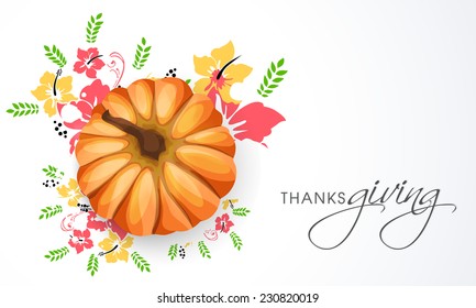 Happy Thanksgiving Day celebrations with pumpkin on colourful flowers decorated grey background.