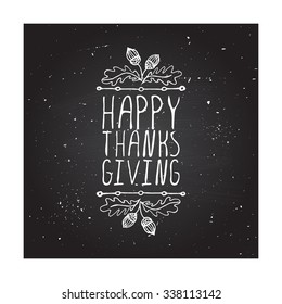 Happy Thanksgiving. Hand sketched graphic vector element with acorns and text on chalkboard background.  