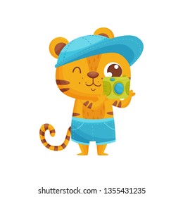 Happy tiger with camera on white background.