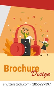 Happy tiny people listening spiritual music near huge headphones flat vector illustration. Young guy holding star and girl playing guitar. Lifestyle and technology concept
