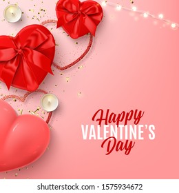 Happy Valentine's Day banner. Vector illustration with realistic red gift boxes, sparkling light garland, candles, air balloon and confetti on pink background.