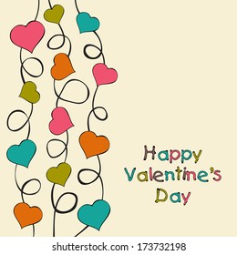 Happy Valentines Day celebration concept with colorful heart shape on a tree branch on abstract background. 