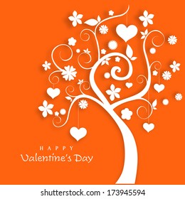 Happy Valentines Day celebration concept with beautiful floral and heart shape decorated tree on orange background. 