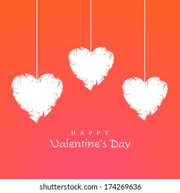 Happy Valentines Day celebration concept with hanging heart shaped on orange background. 