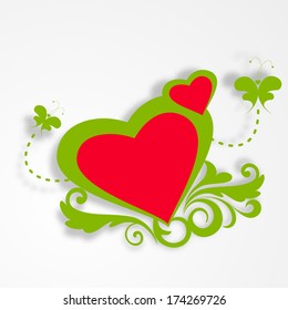 Happy Valentines Day celebration concept with red heart shape on green floral decorated grey background. 