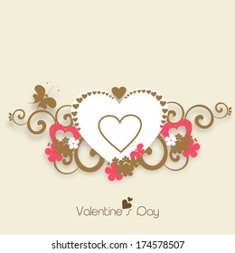 Happy Valentines Day celebration concept with stylish heart shape on floral decorated brown background. 