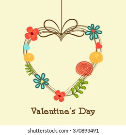 Happy Valentine's Day celebration with creative hanging heart decorated by colorful flowers.