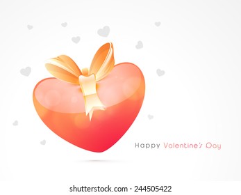 Happy Valentines Day celebration with glossy heart and ribbon on grey background.