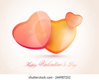 Happy Valentines Day celebration with glossy hearts on shiny background.