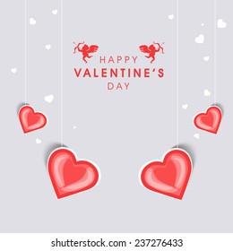Happy Valentine's Day celebration greeting card with beautiful hanging red hearts on grey background.