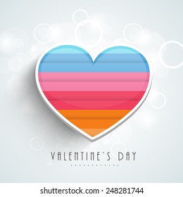 Happy Valentine's Day celebration love greeting card with colorful heart on shiny sky blue background.