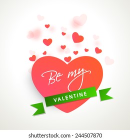 Happy Valentines Day celebration with text Be My Valentine on heart and green ribbon.