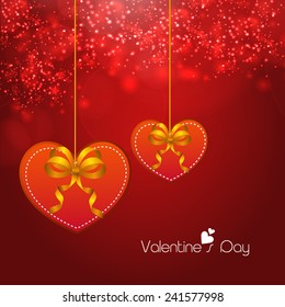Happy Valentine's Day celebrations with hearts and ribbons hanging on shiny red background.