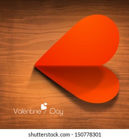Happy Valentines Day concept with red fold paper heart on wooden background. 