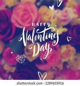 Happy Valentines Day - Greeting card. Brush calligraphy greeting and hand drawn hearts on a blurred flowers background. Vector illustration.