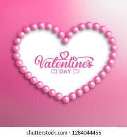 Happy Valentines Day hand drawn lettering in the center of the heart of pink pearls. Ready handwritten, calligraphy text.