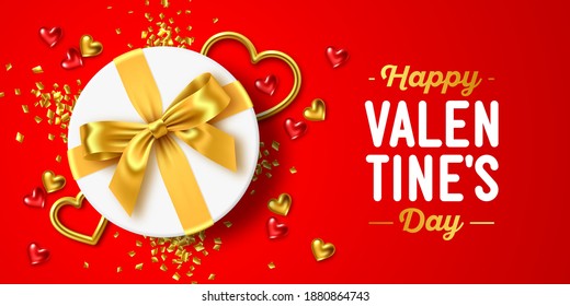 Happy Valentine's Day holiday. Romantic composition of white round gift box with gold ribbon bow, gold jewelry hearts and confetti on red background. For design of greeting card, banner, poster