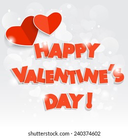 Happy Valentine's Day! Red heart on a silver bokeh background.