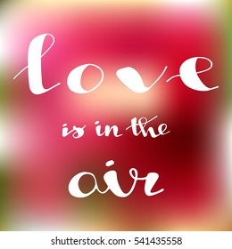Happy Valentine's Day. Typographical background "Love is in the Air" on the blurred background.
