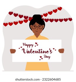 Happy woman holding a poster with text Happy Valentine's Day and red hearts. Love concept. Happy Valentine's Day wallpaper, poster, postcard or congratulation.