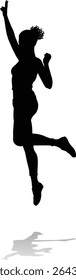 A happy woman jumping for joy in mid air silhouette person concept