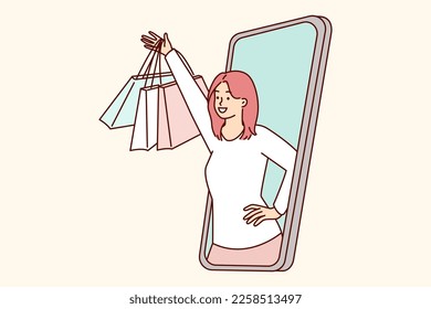 Happy woman peeking out of mobile phone screen raising hand with packages from clothing store rejoices in cool shopping. Buyer of online store who made order through online application